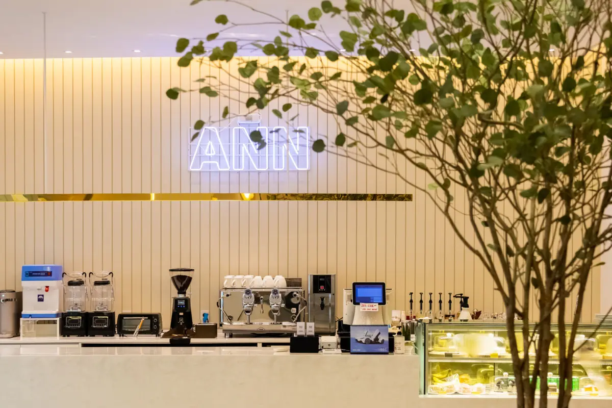 화이트 루버와 실내 조경이 어우러진 모던 카페